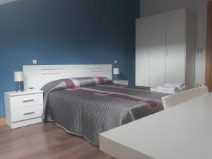 a bedroom with a large bed and a white dresser at Ático Vista Alegre in Lerma