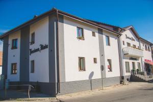 a large white building on the side of a street at Pensiunea Iliada in Sibiu