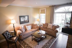 a living room with a couch and a coffee table at 124 on Queen Hotel & Spa in Niagara on the Lake