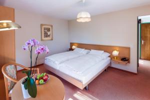 Un pat sau paturi într-o cameră la Hotel & Spa Cacciatori