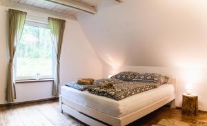 A bed or beds in a room at Chata Kamenie