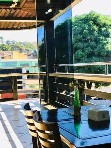 里奧韋爾迪的住宿－Acapu Hotel，阳台配有一张带椅子的蓝色桌子和一瓶水