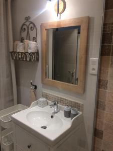 a bathroom with a sink and a mirror at Chez Adeline in Céreste