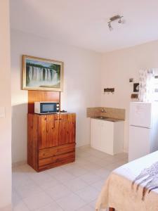 a bedroom with a microwave on a wooden dresser at Sunflower Self-Catering in Walvis Bay