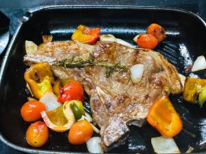 a pan of food with meat and vegetables at Mt Pleasant B'n'B in Harare