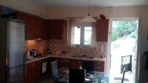 a kitchen with a refrigerator and a table in it at VILLA MERASTRI in Balíon +19 photos