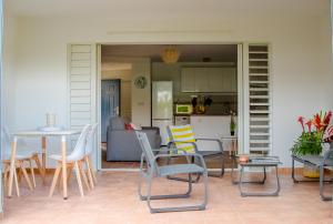 a patio with chairs and a table and a kitchen at T2 de standing résidence Le Marisol in Pointe-à-Pitre