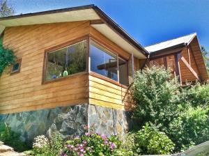 a house with a large window on the side of it at Hermosa Casa en Valdivia in Valdivia