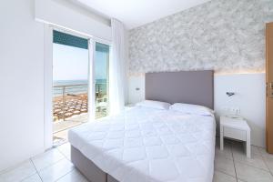 Postel nebo postele na pokoji v ubytování Hotel Columbia & Ninfea