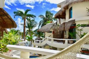 a hammock in front of a resort at Playa Palms Beach Hotel in Playa del Carmen