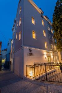 a building with a fence in front of it at Residence Stine in Split