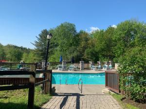 a swimming pool with chairs and a light pole next to it at Indian Head Resort in Lincoln