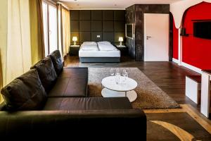 a living room with a couch and a bed at Hotel SleepInn Volkspark in Hamburg