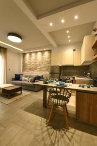 a kitchen and living room with a couch and a table at Sunny Luxury Suite Stone in Kavála