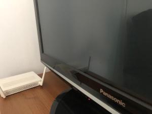 a flat screen tv sitting on top of a table at Sportarena & Stadion Apartman H-39 in Budapest
