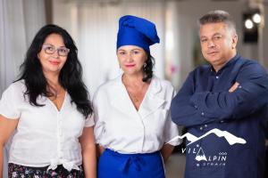 a man and two women standing next to each other at Vila Alpin in Straja