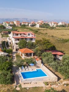 an aerial view of a villa with a swimming pool at Apartments Crljenko in Povljana