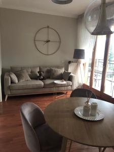 a living room with a table and a couch at Suite LAGO e relax in Campione dʼItalia +12 photos