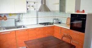 a kitchen with wooden cabinets and a wooden table at Borgo Piazza in Catanzaro Lido