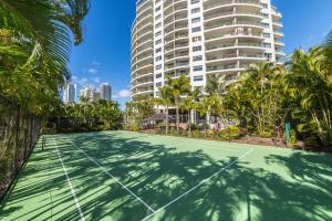 a tennis court in front of a tall building at The Meriton Apartments on Main Beach in Gold Coast