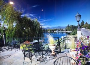 a patio with tables and chairs and a view of a lake at Swan River Inn in Bigfork