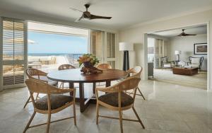 a dining room table and chairs in a room at Four Seasons Resort Oahu at Ko Olina in Kapolei