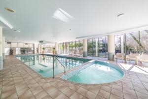 a large swimming pool in a building with windows at The Meriton Apartments on Main Beach in Gold Coast