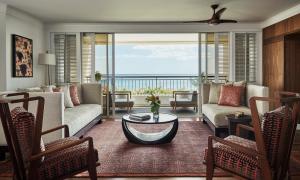 a living room with a couch and a table at Four Seasons Resort Oahu at Ko Olina in Kapolei