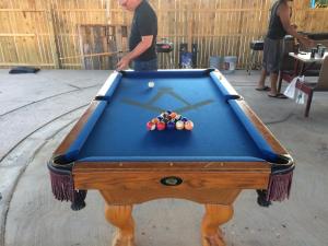 a man standing in front of a pool table at Relax Inn Goldthwaite in Goldthwaite