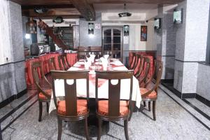 a dining room with a long table and chairs at Hotel Karl Residency in Mumbai