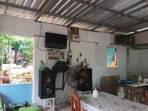 a room with a table with a fan and a television at Sin U Rai Resort in Ko Larn