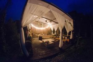 a pavilion with a white canopy with lights at Glamping Tierra Dulce in Supatá +41 photos