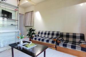 a living room with two couches and a coffee table at Batik Trinidar Homestay in Yogyakarta