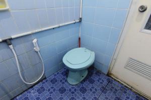 a bathroom with a blue toilet in a stall at Batik Trinidar Homestay in Yogyakarta