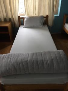 two beds in a room with a window at Nepalaya Eco Hostel in Pokhara