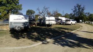 a group of rvs parked on the side of a dirt road at Taroom Caravan & Tourist Park in Taroom