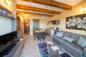 a living room with a couch and a table at Quayside Apartments in Marsaxlokk