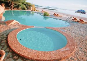 a swimming pool on the beach next to a beach at Wild Beach Boutique Resort in Ninh Phuoc