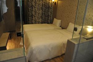 Postel nebo postele na pokoji v ubytování Maple Hotel