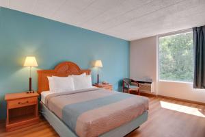 a hotel room with a bed and a window at Motel 6-Clarion, PA in Clarion