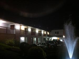 a water fountain in front of a house at night at Liberty Inn Old Saybrook in Old Saybrook
