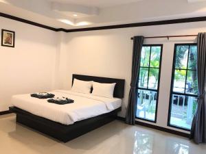 Ένα ή περισσότερα κρεβάτια σε δωμάτιο στο Sabaidee mansion&hotel