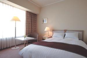 Postel nebo postele na pokoji v ubytování Miyako Hotel Yokkaichi