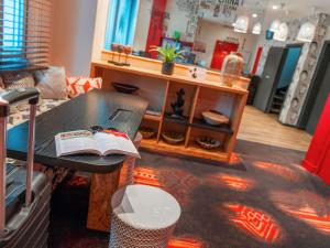 a room with a table with a book on it at ibis Styles Paris Boulogne Marcel Sembat in Boulogne-Billancourt