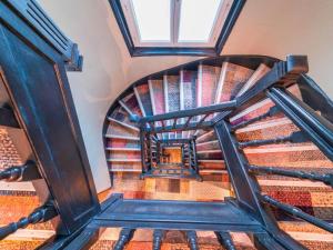 a spiral staircase in a building with a window at ibis Styles Paris Boulogne Marcel Sembat in Boulogne-Billancourt