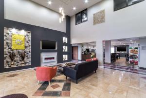 a lobby with a couch and chairs and a fireplace at Quality Inn & Suites Augusta I-20 in Augusta