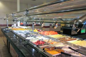 a buffet line with many different types of food at Clarion Hotel & Suites Williston in Williston +17 photos
