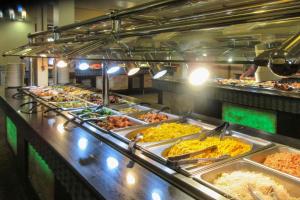 a buffet line with many different types of food at Clarion Hotel & Suites Williston in Williston