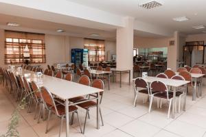 a dining room with tables and chairs at GYM Inn in Tashkent
