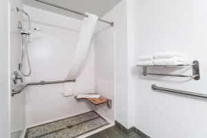 a white bathroom with a shower and towels at Quality Inn & Suites Augusta I-20 in Augusta +28 photos
